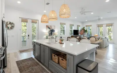 a kitchen with a sink and a living room at Sweet Lu-Sea by Oversee 30A in Santa Rosa Beach