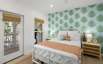 a bedroom with a bed with a green leafy wall at Sweet Lu-Sea by Oversee 30A in Santa Rosa Beach