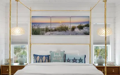 a bedroom with a canopy bed with a beach view at Good Times and Tan Lines by Oversee 30A in Santa Rosa Beach