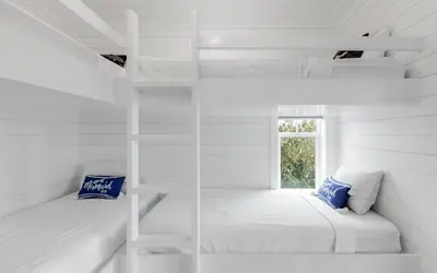 two bunk beds in a white room with a window at Good Times and Tan Lines by Oversee 30A in Santa Rosa Beach