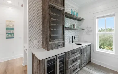 a kitchen with wooden cabinets and a sink at Good Times and Tan Lines by Oversee 30A in Santa Rosa Beach