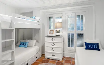 a white bedroom with a bunk bed and a dresser at Gone Coastal by Oversee 30A in Santa Rosa Beach
