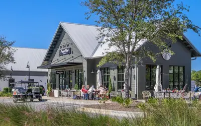 a group of people sitting outside of a building at Gone Coastal by Oversee 30A in Santa Rosa Beach