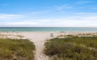 a sandy beach with the ocean in the background at Gone Coastal by Oversee 30A in Santa Rosa Beach