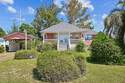 a home with a red and white house at 2340 Grand Oaks Ln home in Panama City Beach