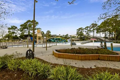 a park with a pool and a playground at 2340 Grand Oaks Ln home in Panama City Beach