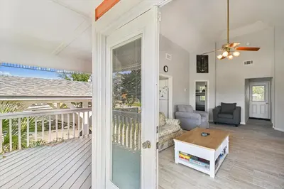 a living room with a view of a balcony at 2340 Grand Oaks Ln home in Panama City Beach