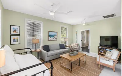 a living room with a couch and a tv at Casa Playa by Oversee 30A in Santa Rosa Beach