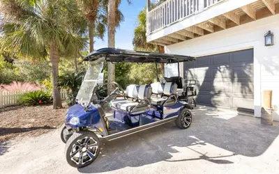 a golf cart parked in front of a house at Casa Playa by Oversee 30A in Santa Rosa Beach