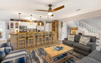 a living room with a couch and a table at Clareon By The Coast by Oversee 30A in Seacrest