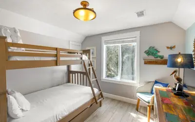 a bedroom with two bunk beds and a window at Clareon By The Coast by Oversee 30A in Seacrest