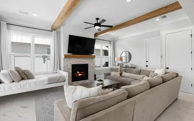 a living room with a couch and a fireplace at Coconut Cove by Oversee 30A in Santa Rosa Beach