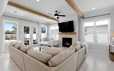 a living room with a couch and a fireplace at Coconut Cove by Oversee 30A in Santa Rosa Beach