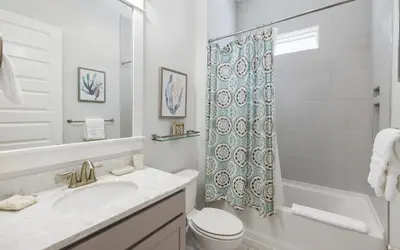 a bathroom with a sink and a toilet and a shower at Coral Retreat by Oversee 30A in Seacrest