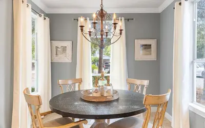a dining room with a table and chairs and a chandelier at Dare To Dream by Oversee 30A in Seacrest