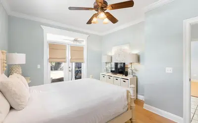 a bedroom with a white bed and a ceiling fan at Dare To Dream by Oversee 30A in Seacrest