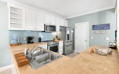 a kitchen with a sink and a stove top oven at Dare To Dream by Oversee 30A in Seacrest