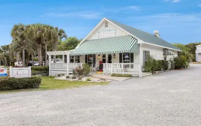 a white building with a sign in front of it at Dare To Dream by Oversee 30A in Seacrest