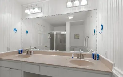 a bathroom with two sinks and a large mirror at Dolphin Run by Oversee 30A in Santa Rosa Beach