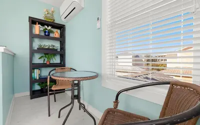 a room with a table and chairs and a window at Dolphin Run by Oversee 30A in Santa Rosa Beach