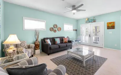 a living room with a couch and a table at Dolphin Run by Oversee 30A in Santa Rosa Beach