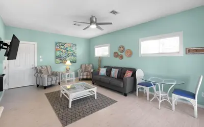 a living room with a couch and a table at Dolphin Run by Oversee 30A in Santa Rosa Beach