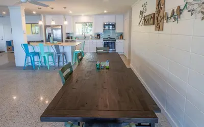 a kitchen and dining room with a wooden table at Easy Breezy by Oversee 30A in Santa Rosa Beach