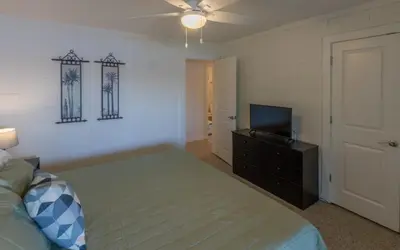a bedroom with a bed and a flat screen tv at Easy Breezy by Oversee 30A in Santa Rosa Beach