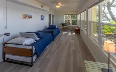 a bedroom with a bed in a room with windows at Easy Breezy by Oversee 30A in Santa Rosa Beach