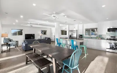 a kitchen and living room with a wooden table and chairs at Easy Breezy by Oversee 30A in Santa Rosa Beach