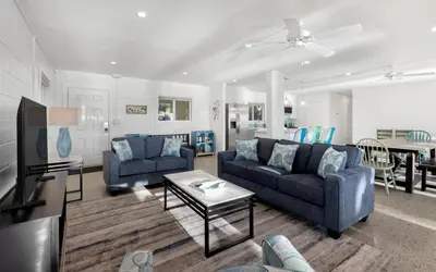 a living room with two couches and a table at Easy Breezy by Oversee 30A in Santa Rosa Beach