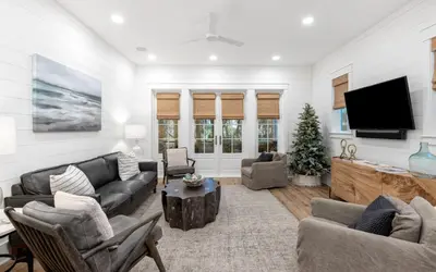 a living room with a couch and a tv at Emerald Tranquility by Oversee 30A in Santa Rosa Beach