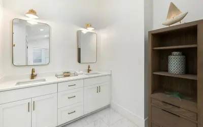 a bathroom with a sink and two mirrors at Emerald Tranquility by Oversee 30A in Santa Rosa Beach