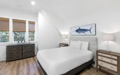 a white bedroom with a bed and two windows at Emerald Tranquility by Oversee 30A in Santa Rosa Beach
