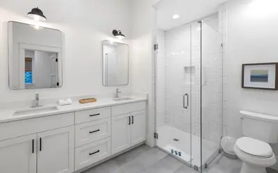 a white bathroom with a shower and a toilet at Emerald Tranquility by Oversee 30A in Santa Rosa Beach