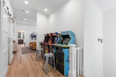 a room with a bunch of video game machines at Emerald Tranquility by Oversee 30A in Santa Rosa Beach