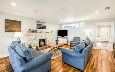 a living room with two blue couches and a fireplace at Family Ties by Oversee 30A in Santa Rosa Beach