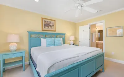 a bedroom with a blue bed and two blue tables at Family Ties by Oversee 30A in Santa Rosa Beach