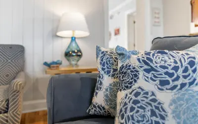a living room with blue and white pillows on a couch at Family Ties by Oversee 30A in Santa Rosa Beach