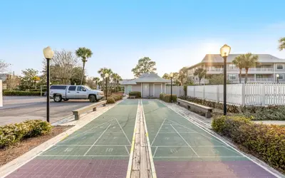 a tennis court in front of a house at Go Coastal by Oversee 30A in Santa Rosa Beach