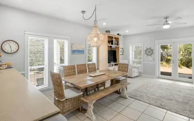a dining room with a wooden table and chairs at Good Life At The C by Oversee 30A in Seacrest