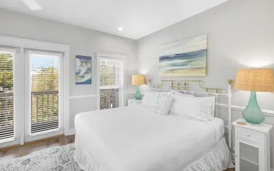 a white bedroom with a bed and two windows at Good Life At The C by Oversee 30A in Seacrest