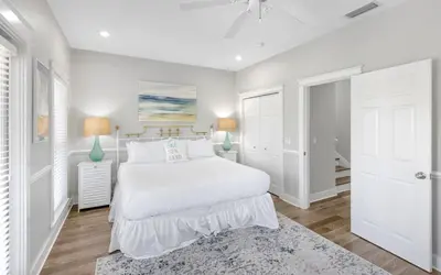 a white bedroom with a bed and two lamps at Good Life At The C by Oversee 30A in Seacrest