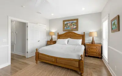 a bedroom with a bed and two night stands and two lamps at Good Life At The C by Oversee 30A in Seacrest