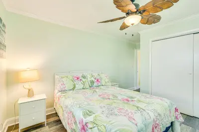 a bedroom with a bed and a ceiling fan at Panama City Home with Fire Pit - Walk to Beaches! in Panama City Beach