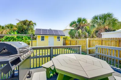 a patio with a table and a grill on a deck at Panama City Home with Fire Pit - Walk to Beaches! in Panama City Beach
