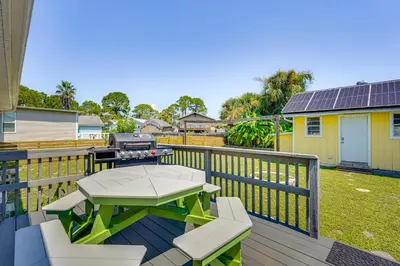 a patio with a table and a grill on a deck at Panama City Home with Fire Pit - Walk to Beaches! in Panama City Beach