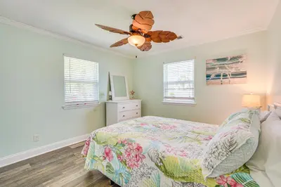 a bedroom with a bed and a ceiling fan at Panama City Home with Fire Pit - Walk to Beaches! in Panama City Beach