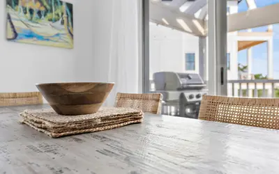 a wooden table with a bowl on top of it at Hideaway Cottage by Oversee 30A in Inlet Beach