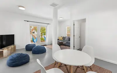 a white living room with a white table and chairs at Hideaway Cottage by Oversee 30A in Inlet Beach